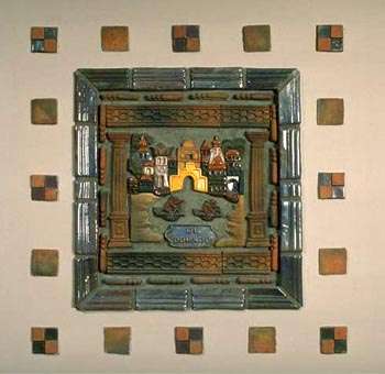 Tile above mantel depicting El Dorado, golden building in center of city